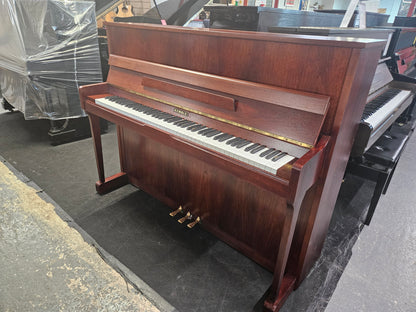Image of a Kemble upright piano with a refinished mahogany cabinet.