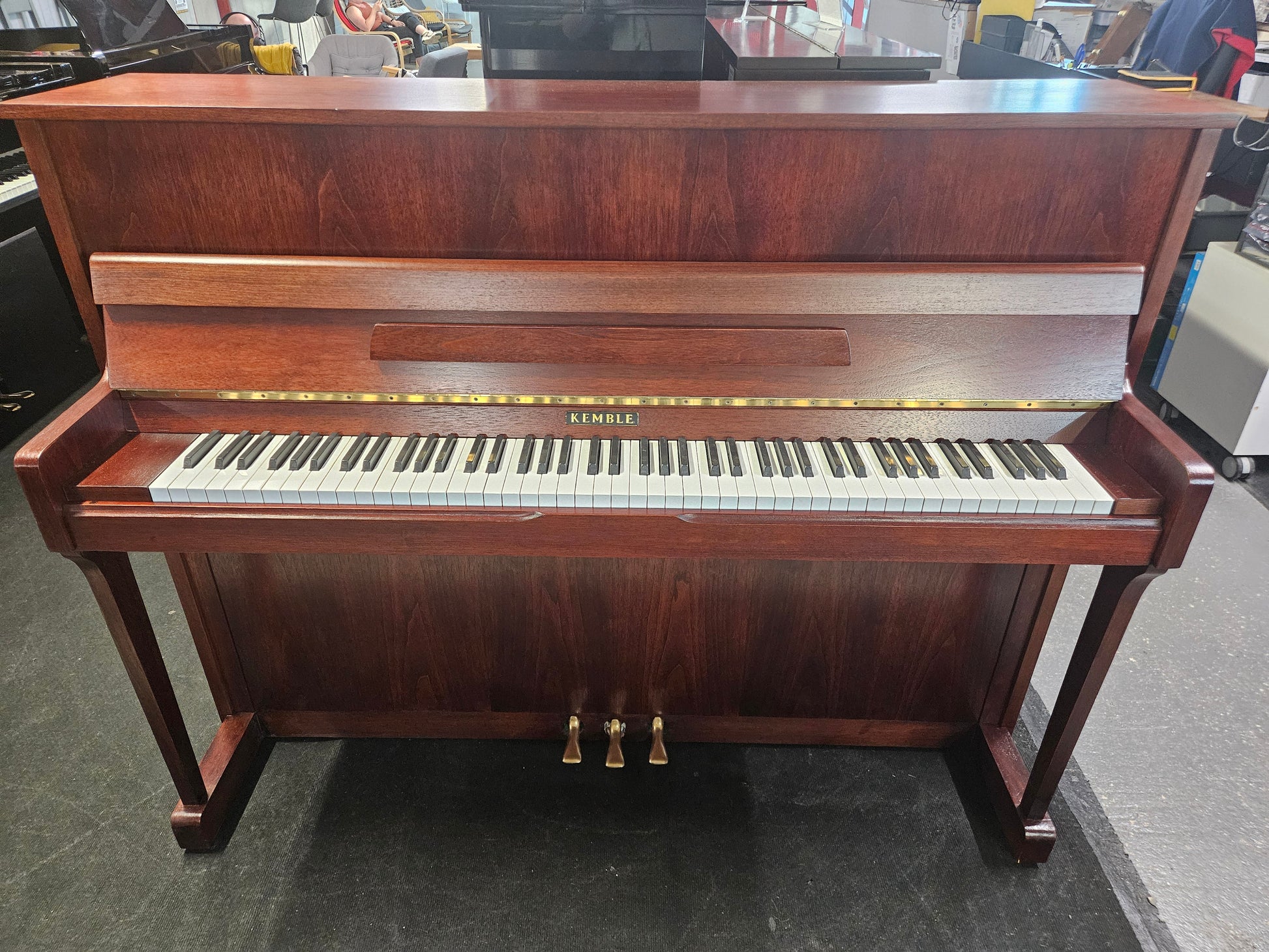 Image of a Kemble upright piano with a refinished mahogany cabinet.